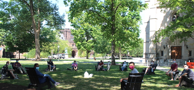 Leifer Lab members  in a circle wearing masks on the lawn at Princeton University.